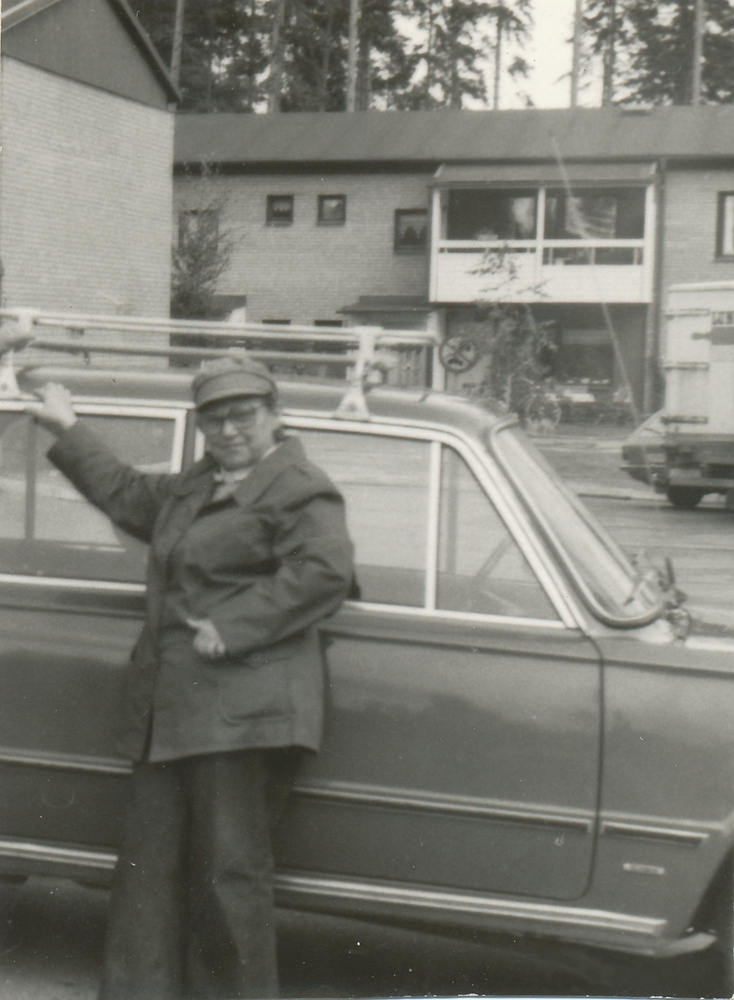 Krystyna Modrzewska in front of a car