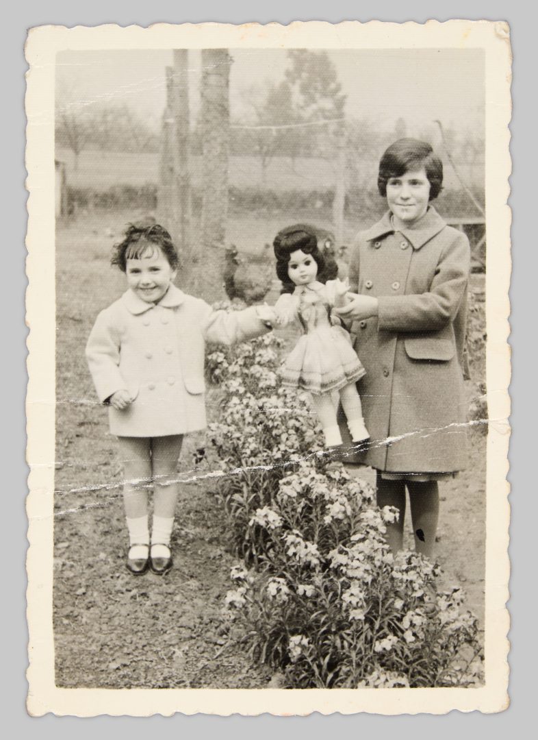 Cristina and Irene in the garden with a doll from Germany. The doll was originally intended as a Christmas present (in Spain, gifts are traditionally given on Epiphany, 6 January), but it arrived much later due to long postal delays. “When you held it by the arms, it could move its legs and walk. That was a sensation at the time,” Cristina recalls. Vega-Gijón, c. 1963 © Cristina Fernández-Moser 